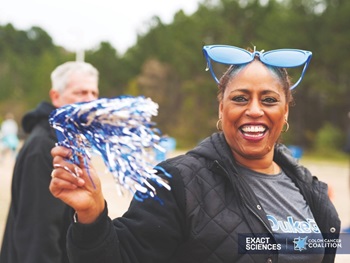 smiling woman with a pom pom
